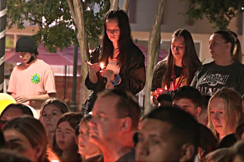 On Saturday night, hours after Abthony Barajas was declared dead, hundreds gathered for a candlelight vigil outside the Corona movie theater where the teens were shot.