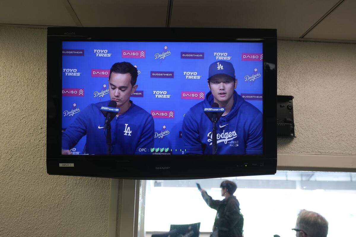 Two men appear on a television screen