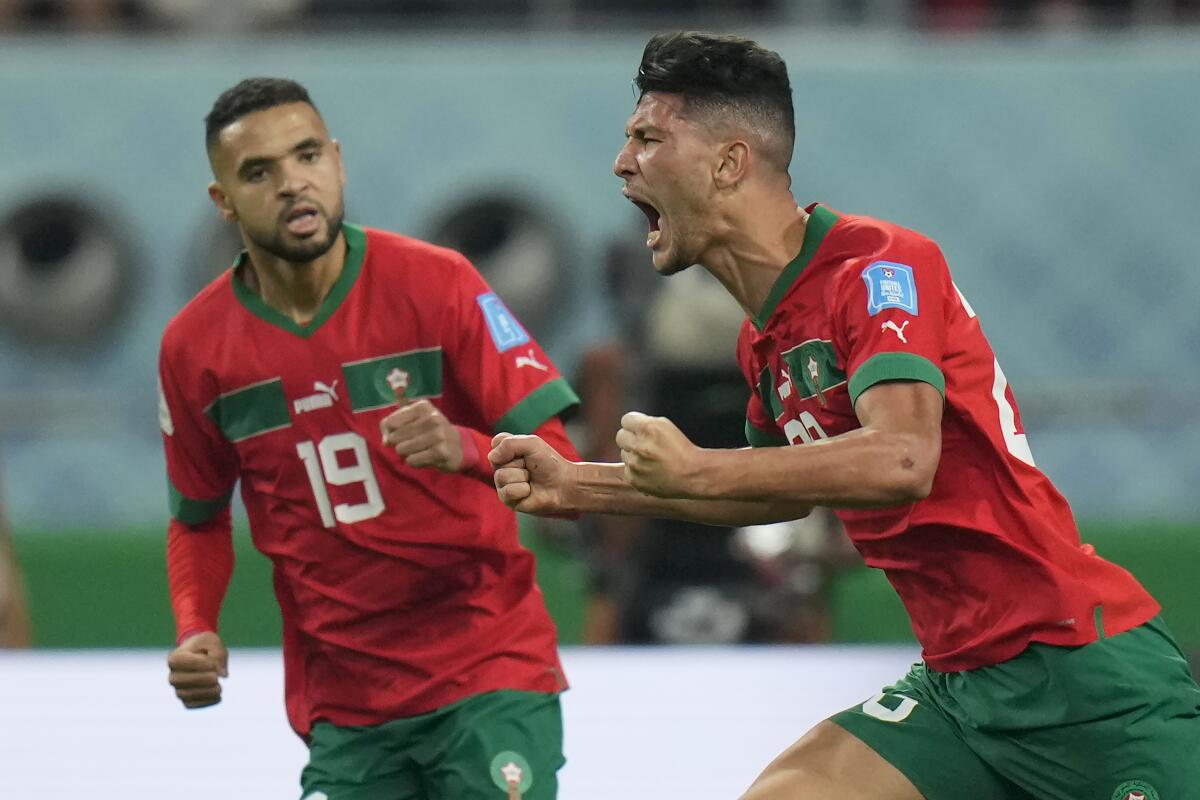 Morocco's Achraf Dari, right, celebrates after scoring against Croatia in the third-place game of the World Cup.