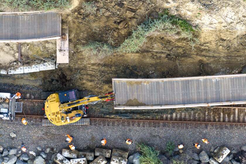 Workers remove a section of the pedestrian beach trail below Buena Vista after a landslide damaged the walkway and stopped rail service between Orange and San Diego counties in San Clemente, CA, on Thursday, January 25, 2024. (Photo by Jeff Gritchen, Orange County Register/SCNG)