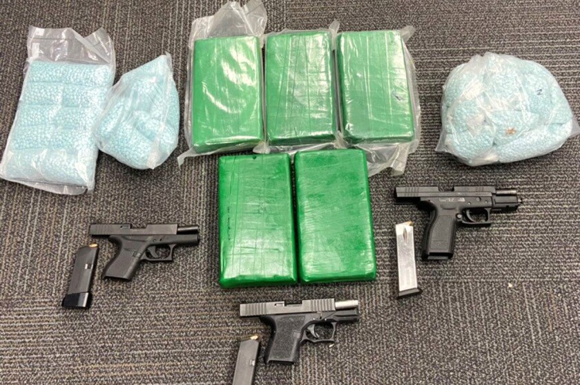 Bags containing fentanyl and powdered fentanyl and three firearms.