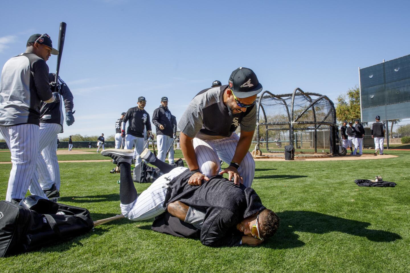 Jose Abreu and Yoan Moncada jump on Tim Anderson after practice during White Sox spring training at Camelback Ranch on Feb. 21, 2018.