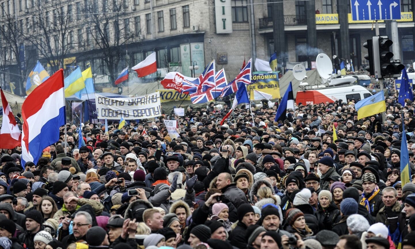 Ukrainians wave various national flags at a rally against Russian intervention in Kiev's Independence Square.