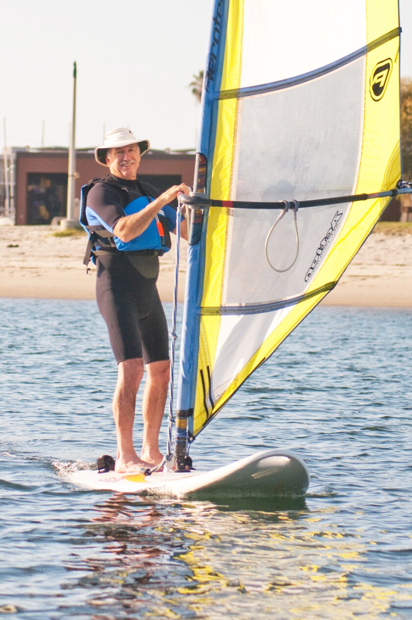 Wind surfing is enjoyed by adults of all ages.