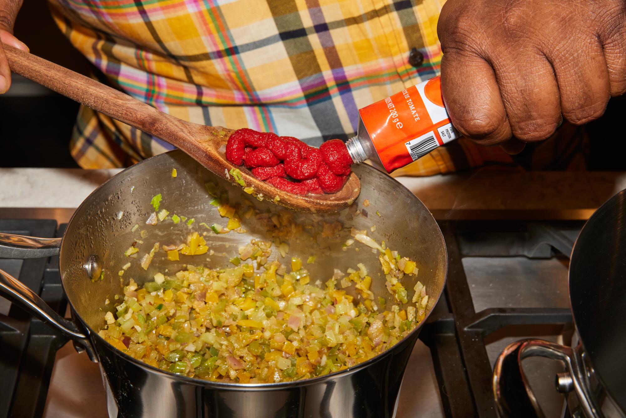 Chef Michael Twitty adds tomato paste to his gumbo.