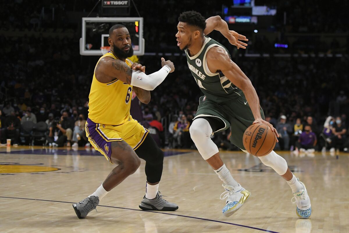 Los Angeles Lakers forward LeBron James (6) guards Milwaukee Bucks forward Giannis Antetokounmpo (34) in the first half in an NBA basketball game, Tuesday, Feb. 8, 2022, in Los Angeles. (AP Photo/John McCoy)