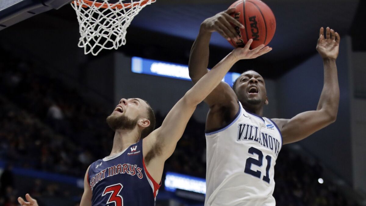 Villanova's Dhamir Cosby-Roundtree (21) blocks a shot by St. Mary's Jordan Ford (3) during the first half of a first round game in the NCAA Tournament on Thursday in Hartford, Conn.