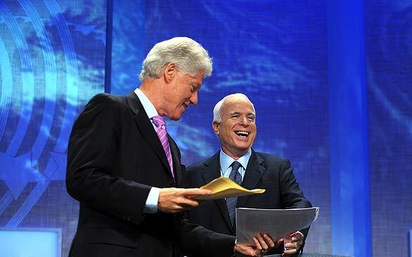 Republican presidential nominee John McCain laughs with former President Bill Clinton after the Arizona senator spoke at the Clinton Global Initiative in New York. Afterward, McCain flew to Washington for talks on the Wall Street bailout plan. In his speech, McCain said he could not stay on the campaign trail while the future of the American economy was at stake. "I'm an old Navy pilot, and I know when a crisis calls for all hands on deck," he said.