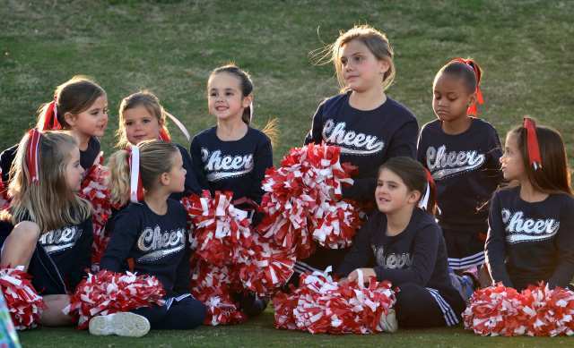 A cheerleading squad gets ready to cheer for the teams.