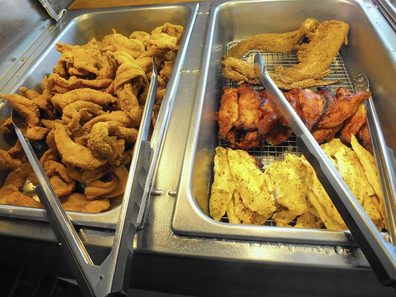 Four kinds of locally raised catfish are served at Larry's Fish House. The whole fried fish, upper right, is the one owner Larry Kelly encourages visitors to try.