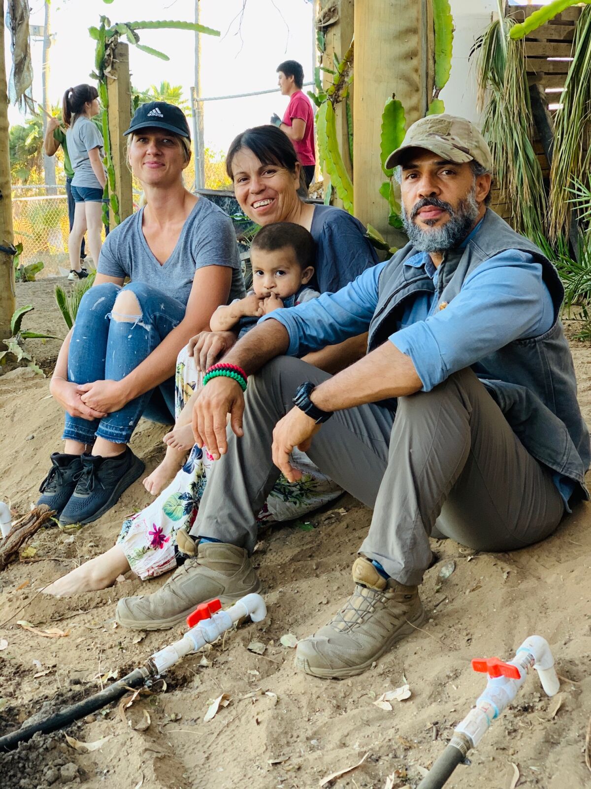 Permaculturist Lety Nuno, center, with her son Max, with Brenda Henry, left, and Anas Canon, right.