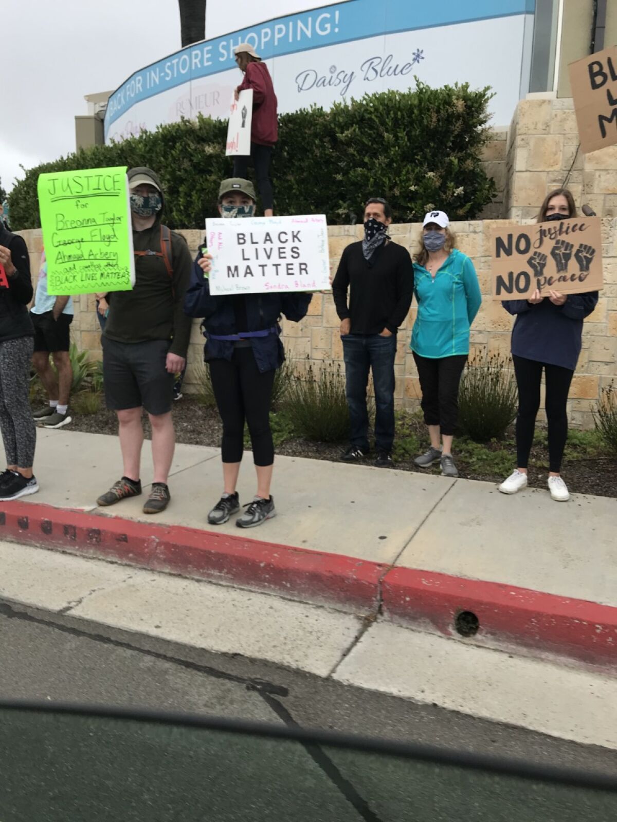 Photos on this page were taken at the peaceful protest in Carmel Valley.