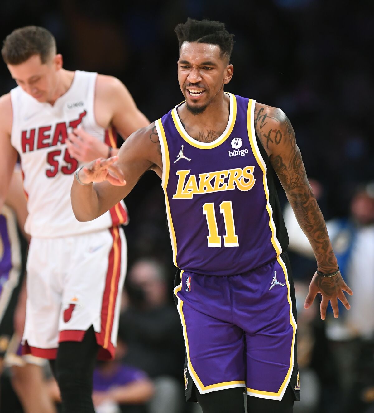 Laker Malik Monk celebrates after hitting a three-pointer against the Heat