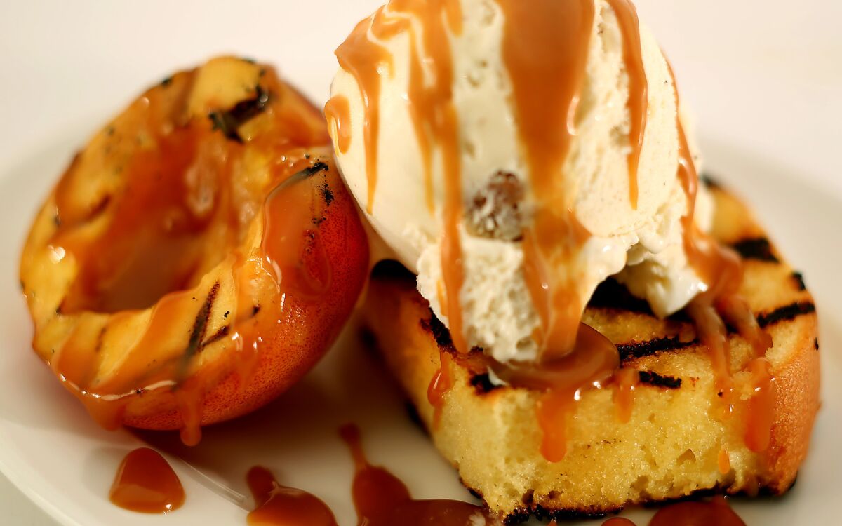 Grilled poundcake with peaches and whiskey caramel sauce