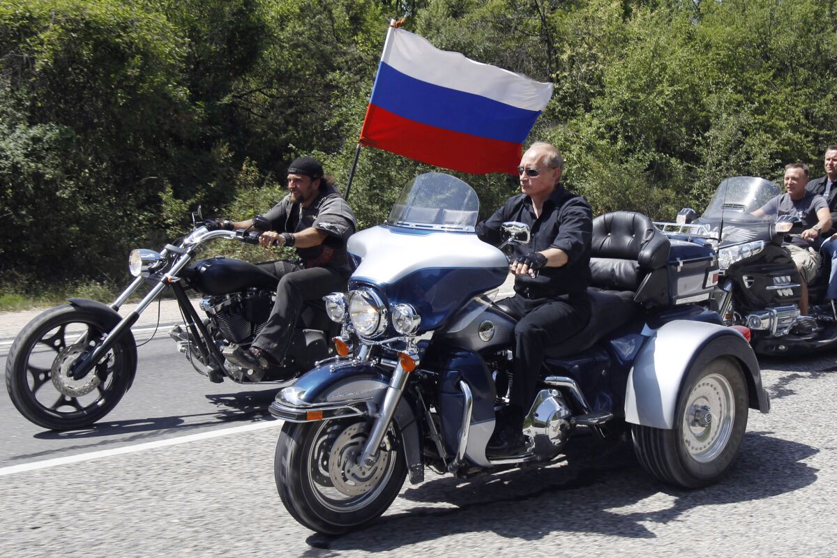 FILE - Russia's Prime Minister Vladimir Putin, foreground, rides a Harley-Davidson Lehman Trike as he arrives for the meeting with Russian and Ukrainian bikers at their camp near Sevastopol, in Ukraine's Crimea Peninsula, on July 24, 2010. Harley-Davidson halted motorcycle shipments to Russia and said its thoughts “continue for the safety of the people of Ukraine.”. (Sergei Karpukhin/Pool Photo via AP, File)