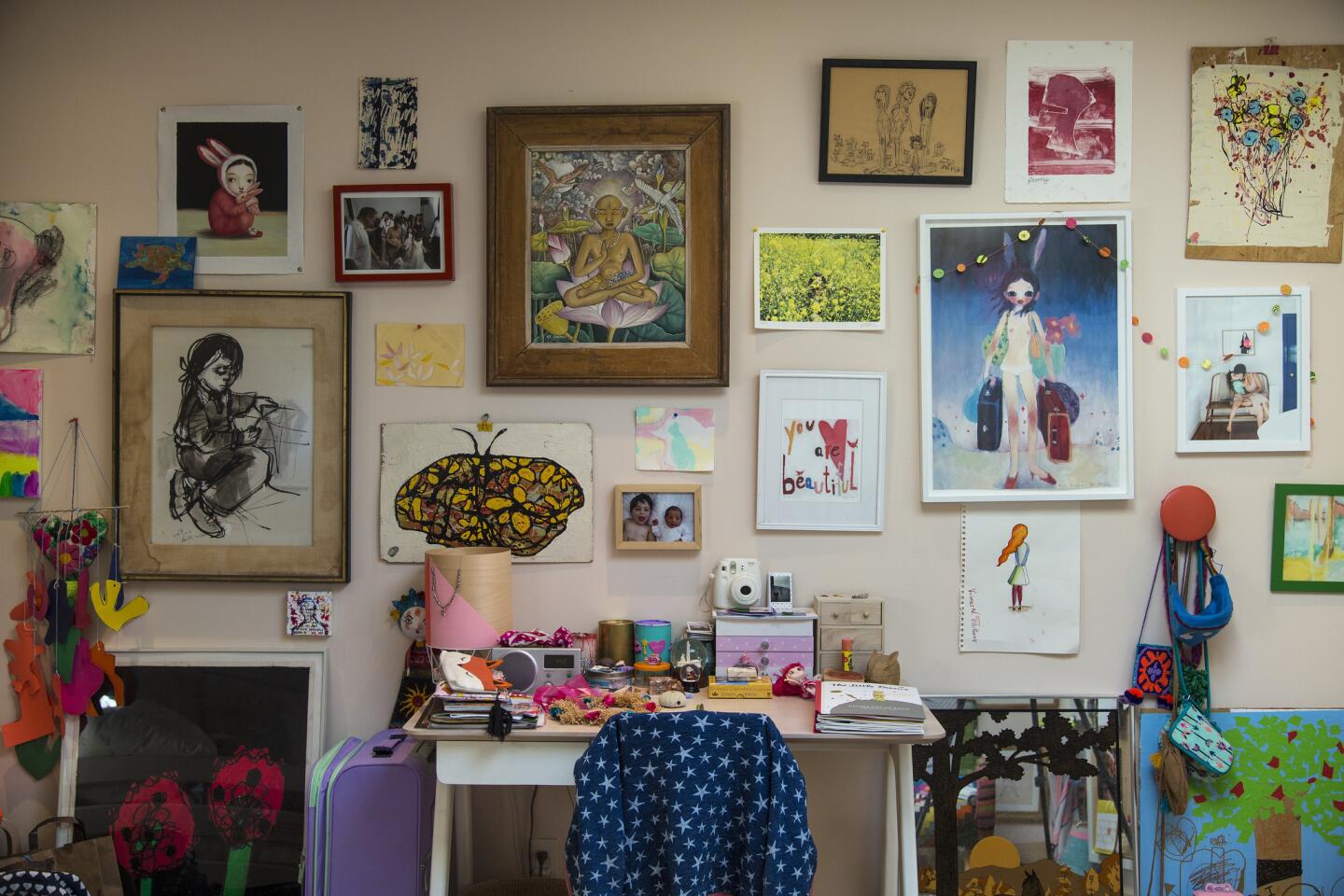 A young girl's desk is surrounded by art. More photos and full story here.