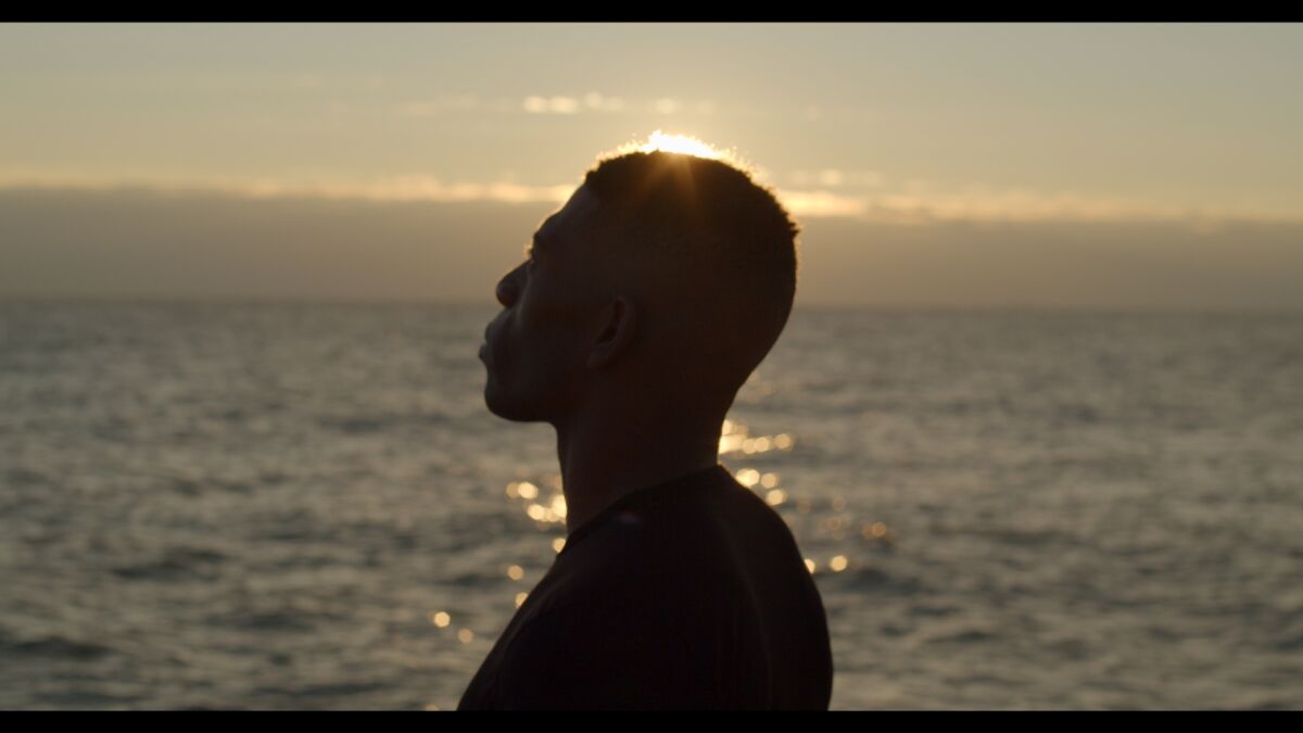 Silhouette of a man against the water