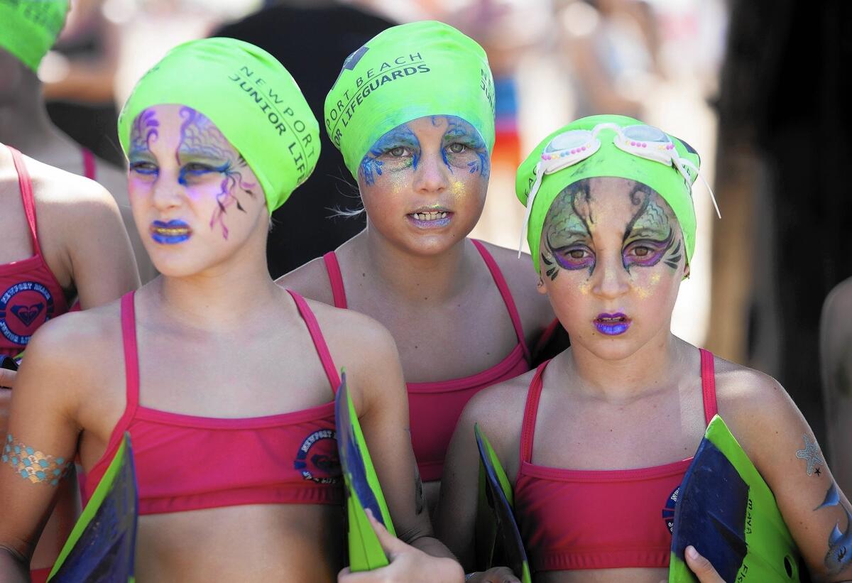 Girls with mermaid face paint wait at the starting line for the girls' group D run during the annual monster mile event for the Newport Beach junior lifeguards at the Balboa Pier in 2015.