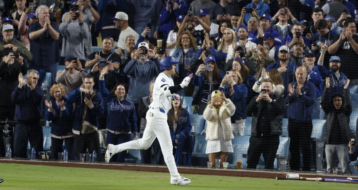 Fans celebrate after Shohei Ohtani hit his first home run as a member of the Dodgers on Wednesday night.