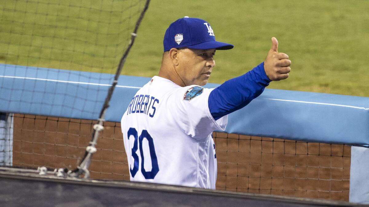 Dodgers manager Dave Roberts gives a thumbs up during Game 5 of the World Series against the Red Sox at Dodger Stadium.