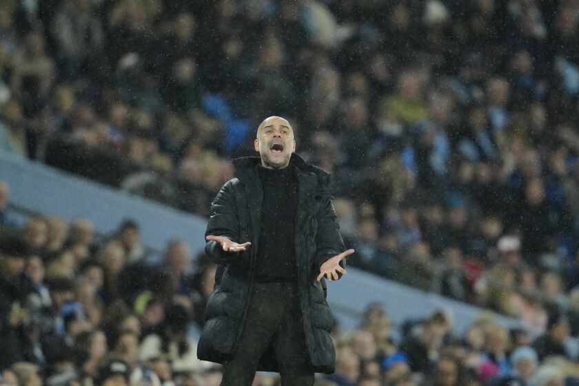 Manchester City's head coach Pep Guardiola reacts during the English FA Cup quarter final soccer match between Manchester City and Burnley at the Etihad stadium in Manchester, England, Saturday, March 18, 2023. (AP Photo/Jon Super)
