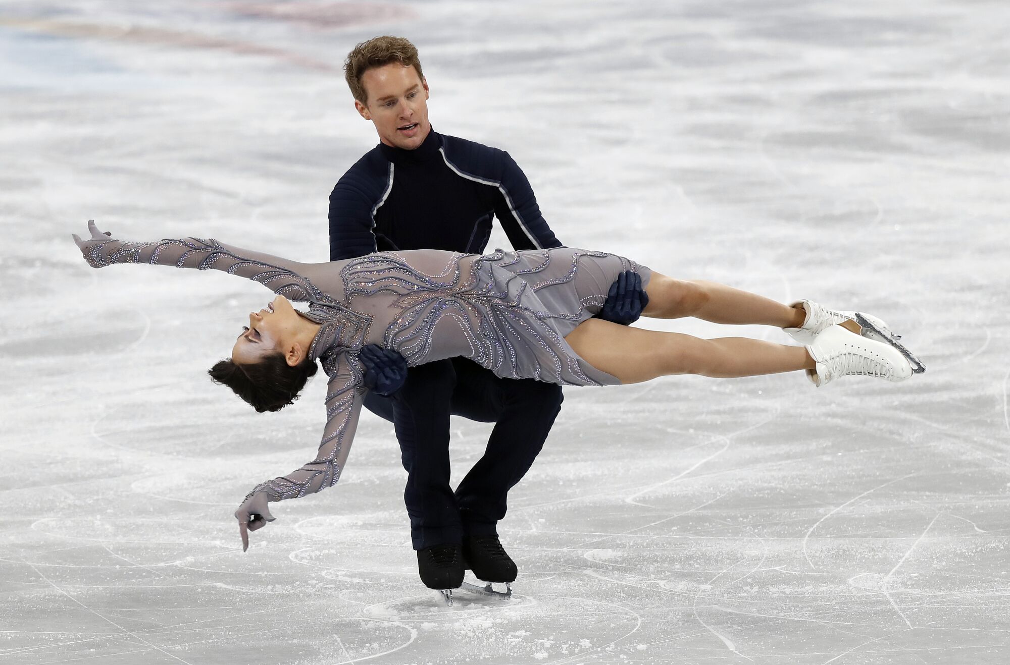 Evan Bates and Madison Chock compete in the ice dance-free dance team event
