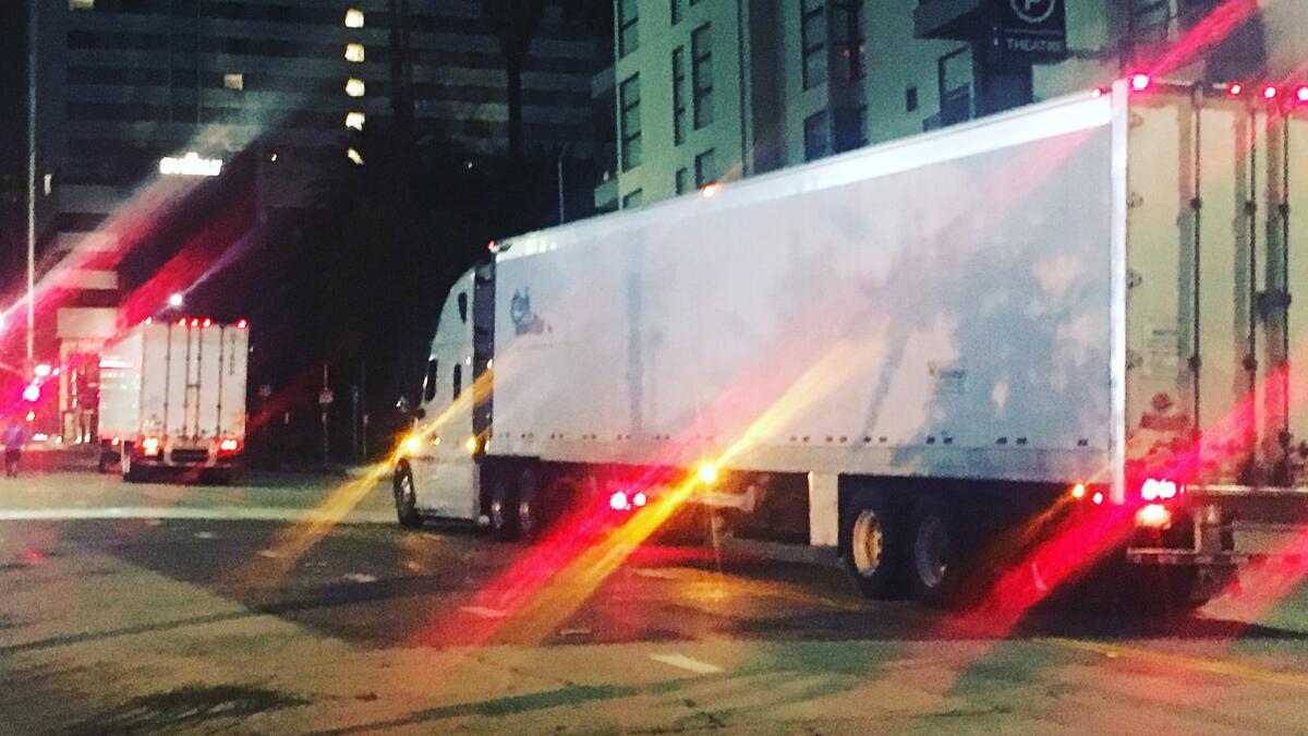 On Hollywood Boulevard, 4:45 a.m., two 18-wheel trucks containing cargo from pieces of the 'Hamilton' set installed at the Hollywood Pantages Theatre for opening night on August 16th.