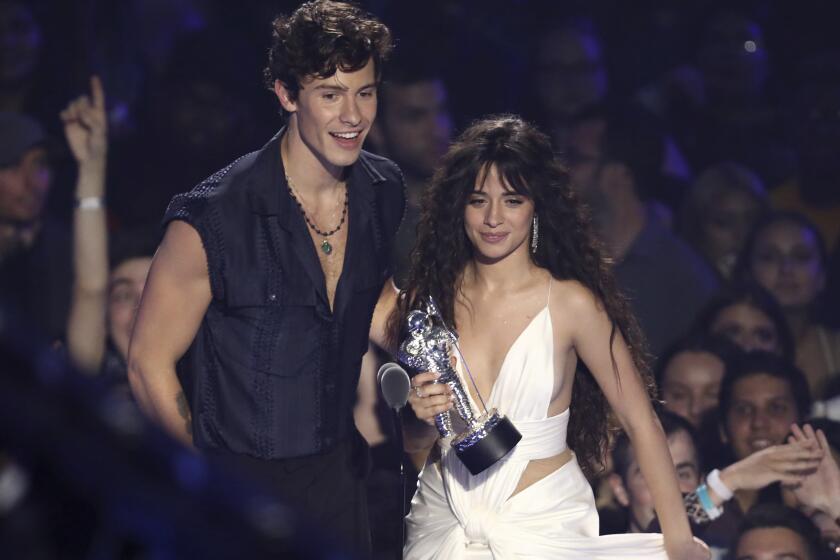 Shawn Mendes, left, and Camila Cabello accept the award for best collaboration for "Senorita" at the MTV Video Music Awards at the Prudential Center on Monday, Aug. 26, 2019, in Newark, N.J. (Photo by Matt Sayles/Invision/AP)