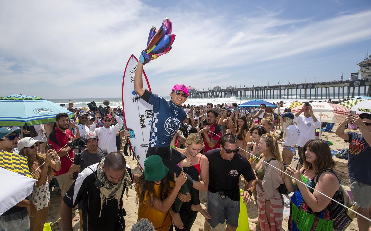Sage Erickson celebrates winning the women's championship at the 2019 U.S. Open of Surfing in Huntington Beach on Sunday.