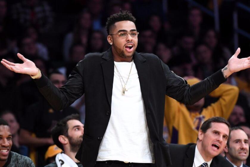 D'Angelo Russell, sidelined by a knee injury reacts to a call from a referee against the Spurs at the Staples Center on Friday.