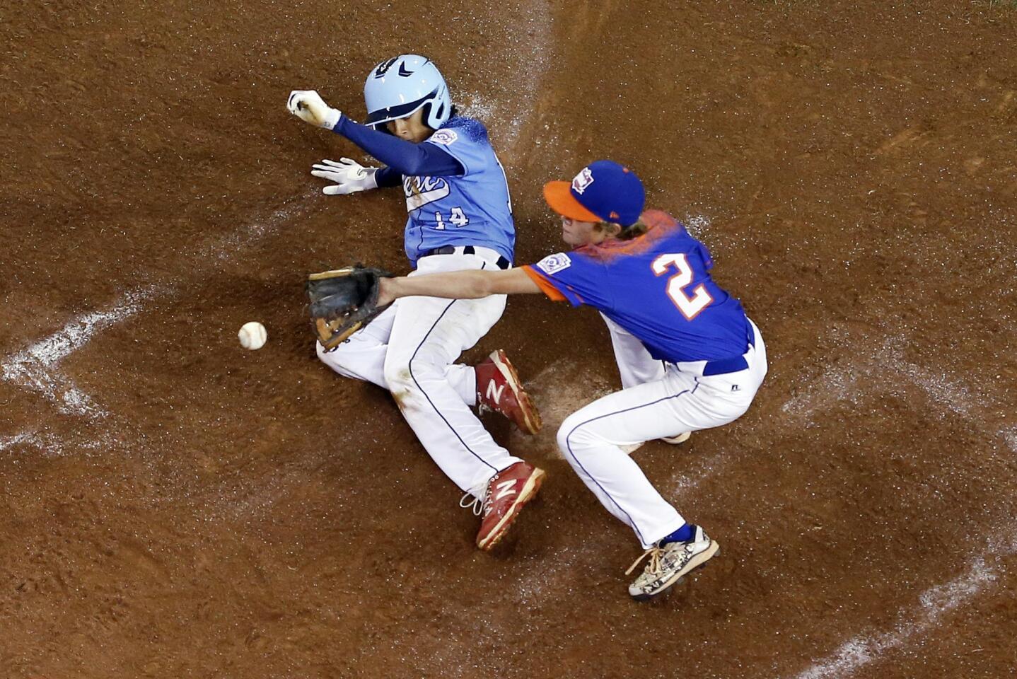 The Bowling Green, Ky. pitcher Eli Burwash (2) covers home as Sweetwater Valley''s Nate Nankil (14) scores on a wild pitch in the fifth inning.