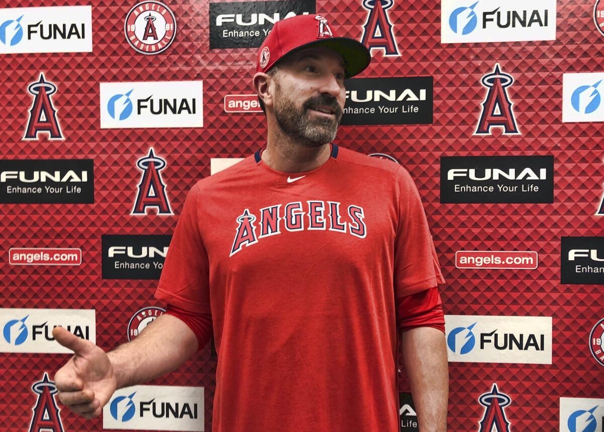 Mickey Callaway speaks in a Los Angeles Angels shirt and hat.