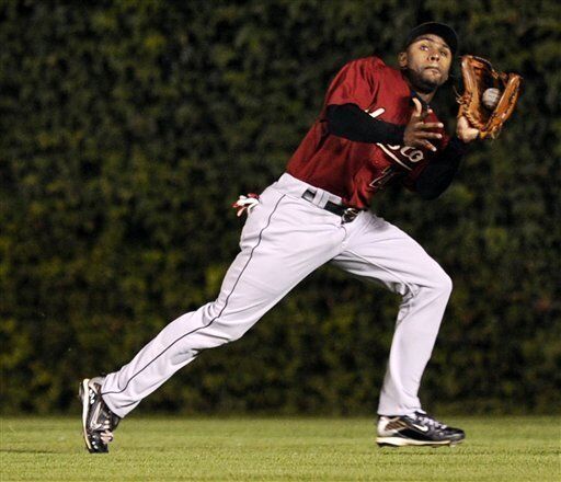 Houston Astros center fielder Michael Bourn catches a fly ball on