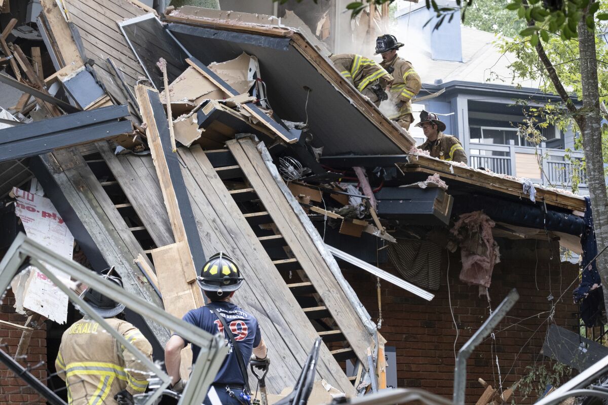 Emergency workers respond following an apartment explosion, Sunday, Sept. 12, 2021, in Dunwoody, Ga., just outside of Atlanta. (AP Photo/Ben Gray)