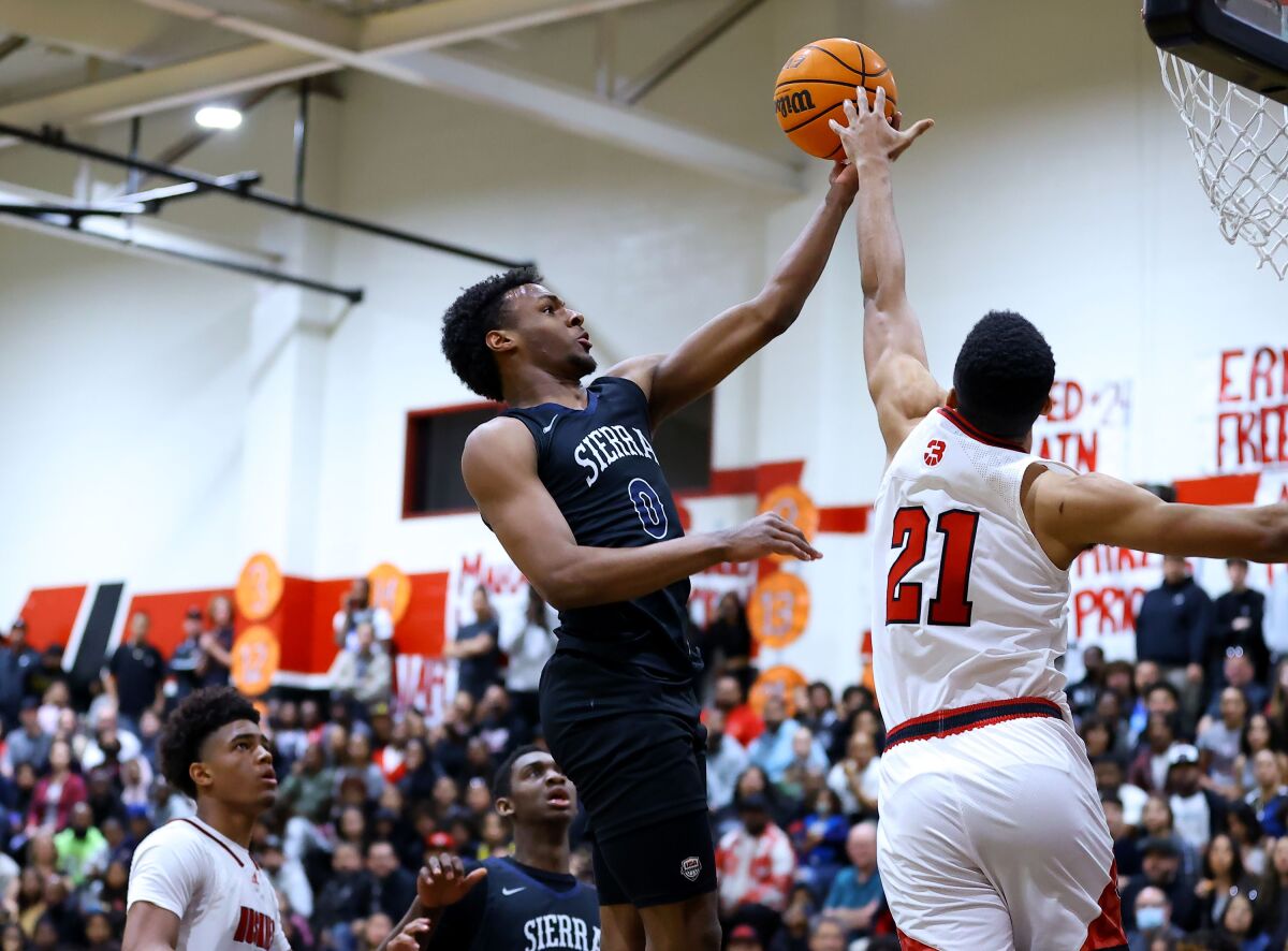 Sierra Canyon guard Bronny James attempts a layup over Corona Centennial forward Aaron McBride.