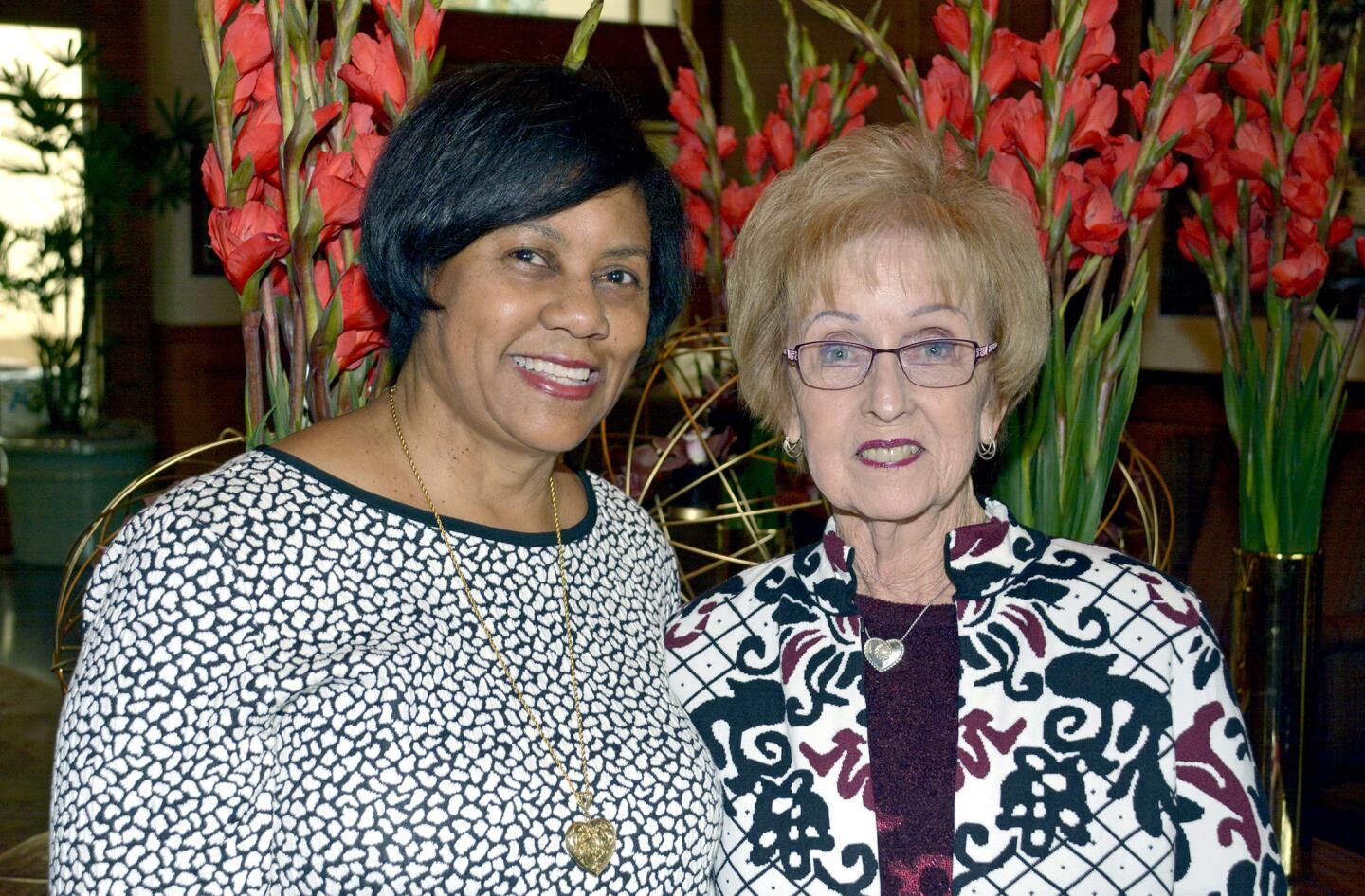 La Providencia Guild President Glenda Jones, left, offered praise and thanks to her predecessor Lynn White-Shelby during the reorganization luncheon held at Oakmont Country Club.