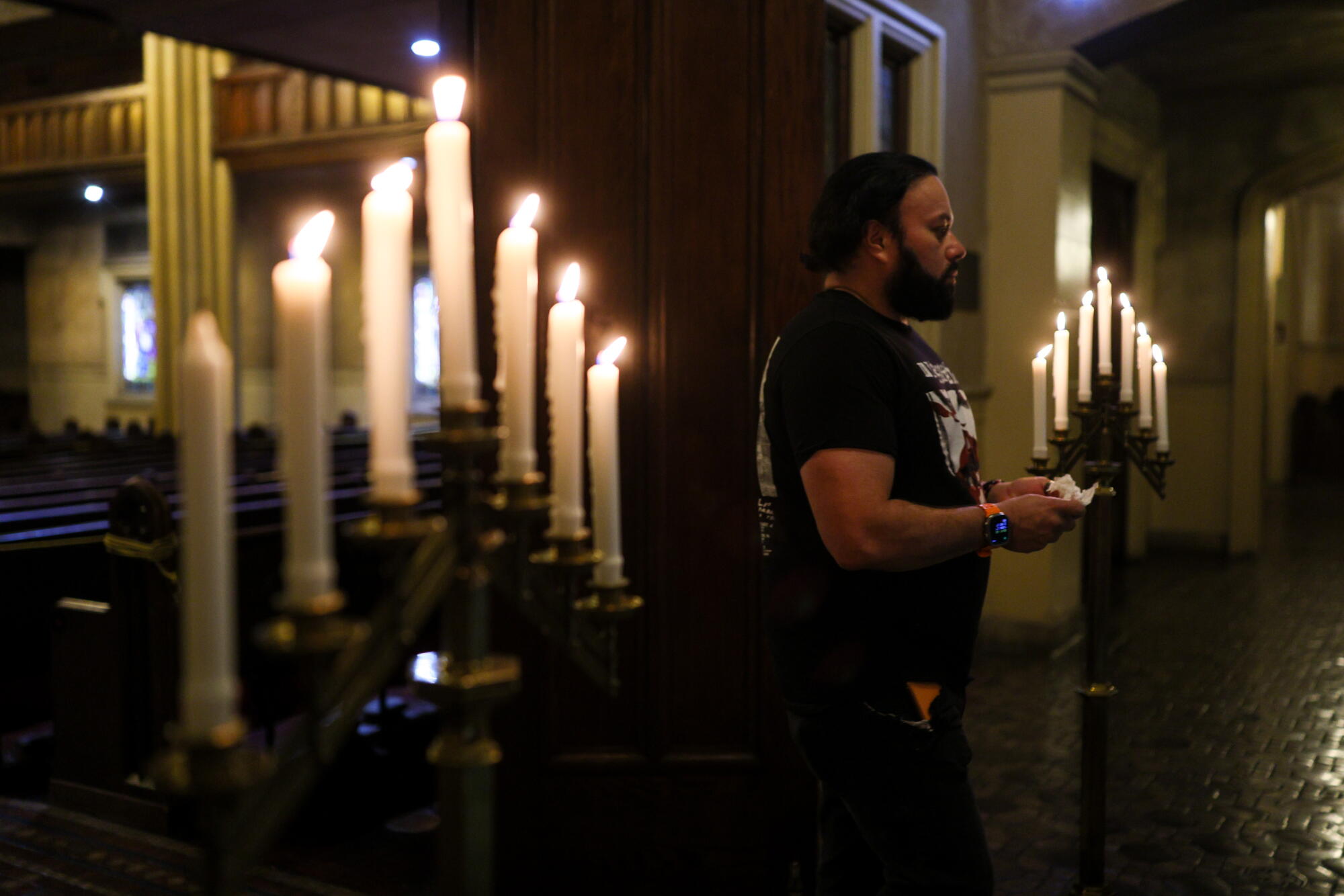 MarAnthony Aparicio walks past lit candles earlier the commencement of My Presbyterian Romance night.