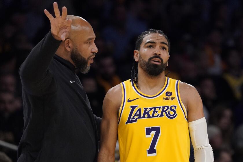 Los Angeles Lakers head coach Darvin Ham talks with guard Gabe Vincent.