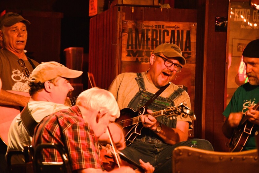 The Station Inn, a favorite Nashville roots music venue, holds bluegrass jam sessions on Sunday nights. Here Carl Caldwell sings and plays mandolin.