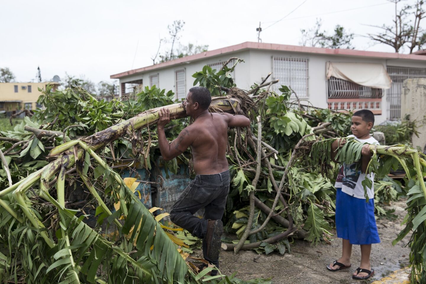 Residents clear the streets after Hurricane Maria made landfall in the Guaynabo suburb of San Juan, Puerto Rico.