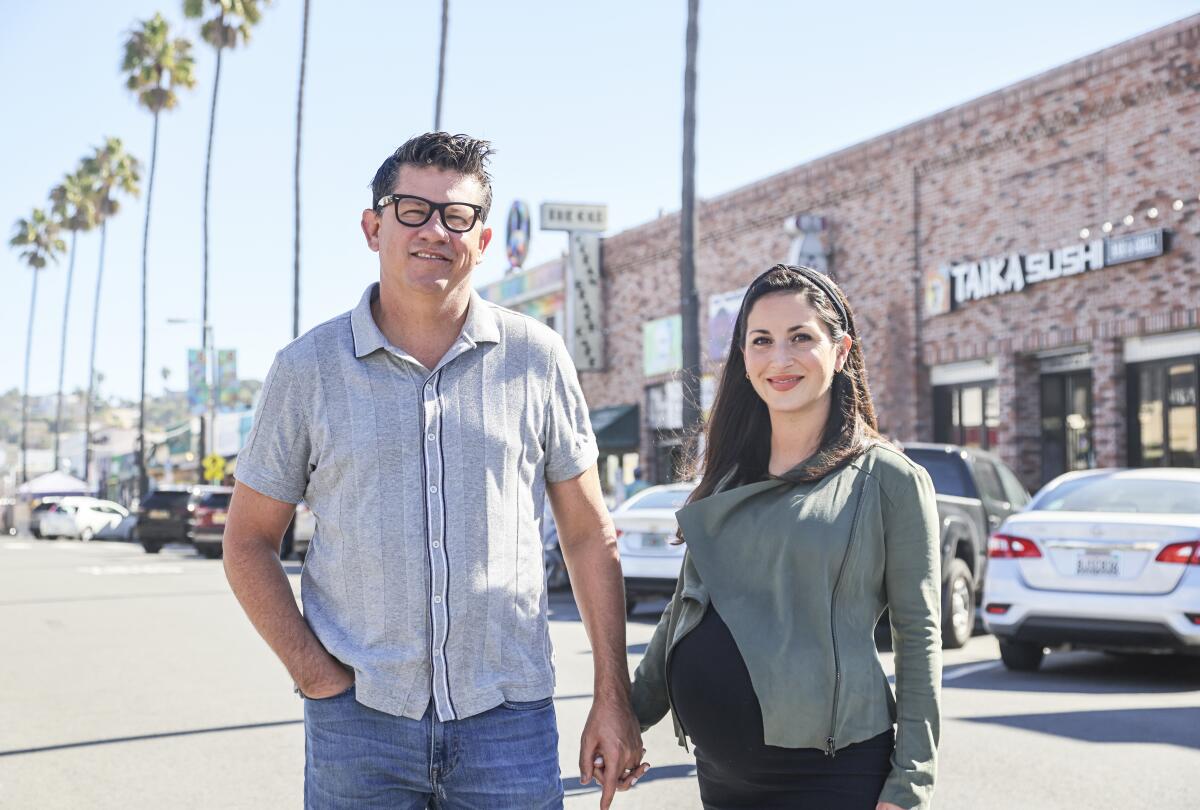 Troy and Claire Johnson, seen here in Ocean Beach, are buying San Diego Magazine.