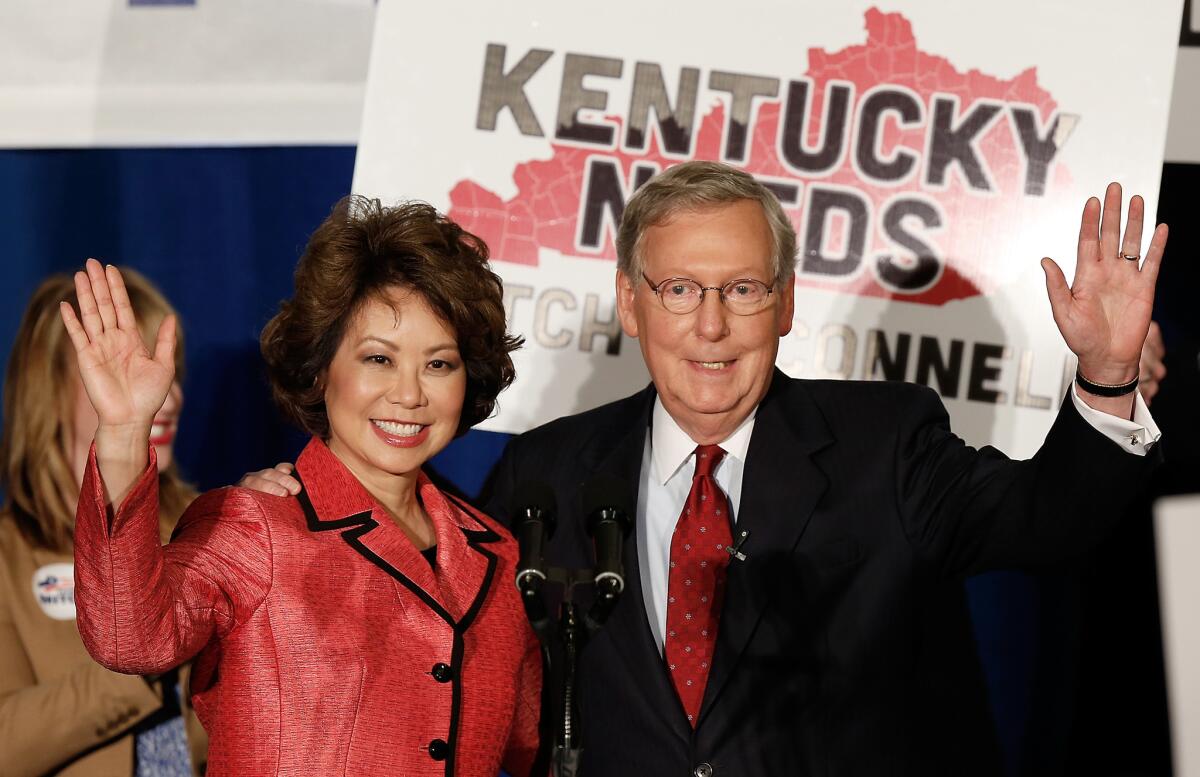 Sen. Mitch McConnell of Kentucky and his wife, Elaine Chao, wave to supporters at a victory celebration Tuesday in Louisville following McConnell's win in Kentucky's GOP primary.