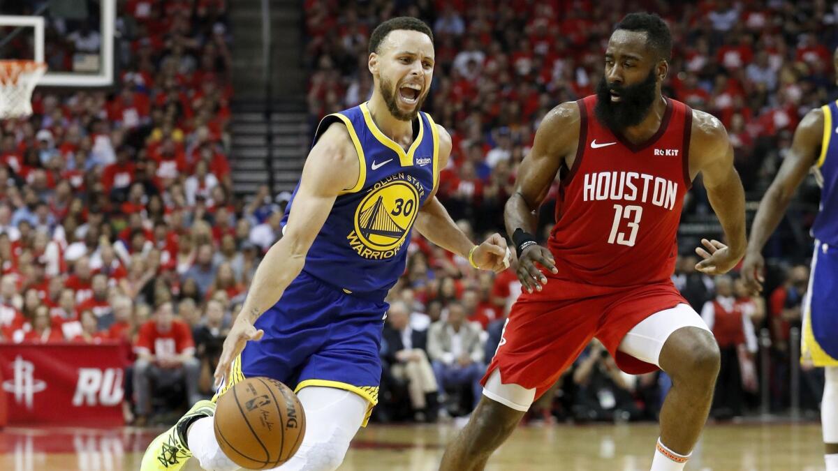 Stephen Curry drives to the basket defended by James Harden in the third quarter.