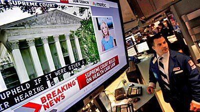 A television monitor on the floor of the New York Stock Exchange headlines the Supreme Court decision.
