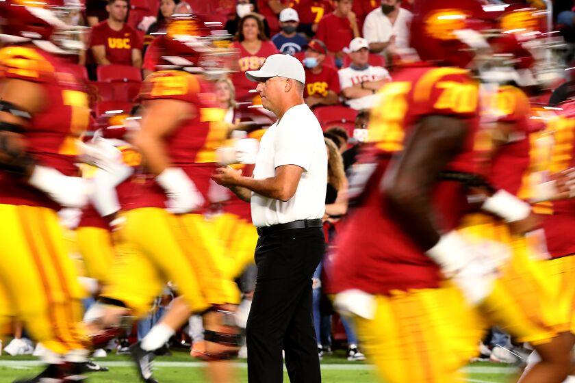LOS ANGELES, CALIF. - SEP 11, 2021. USC head coach Clay Helton watches the Trojans warm up.