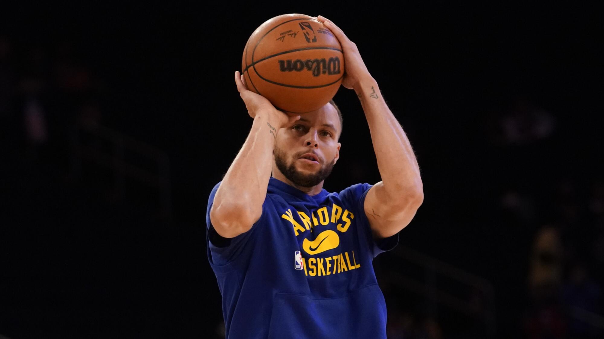 Golden State Warriors guard Stephen Curry warms up with a Wilson NBA game ball.