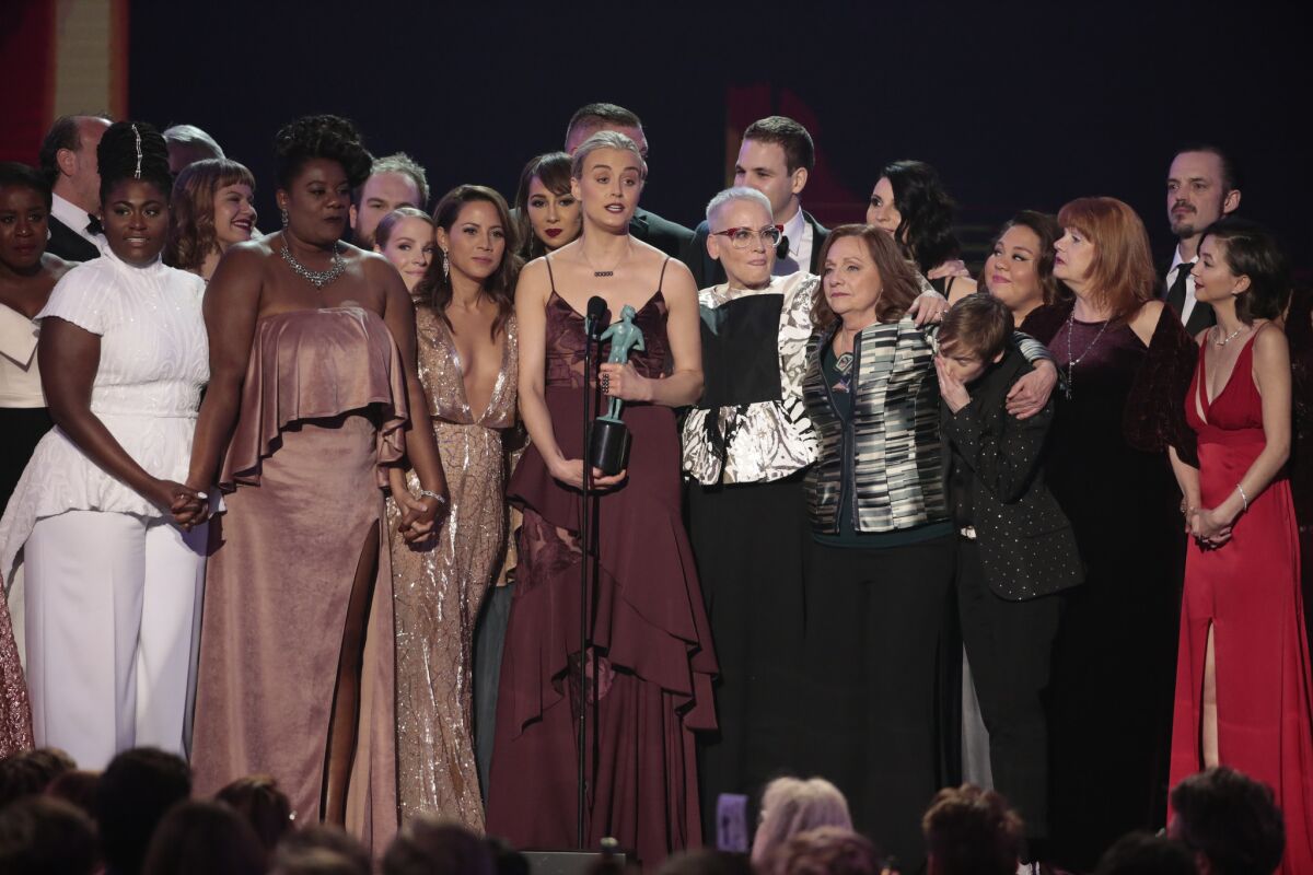 The "Orange Is the New Black" cast gathers onstage after winning for ensemble in a comedy series.