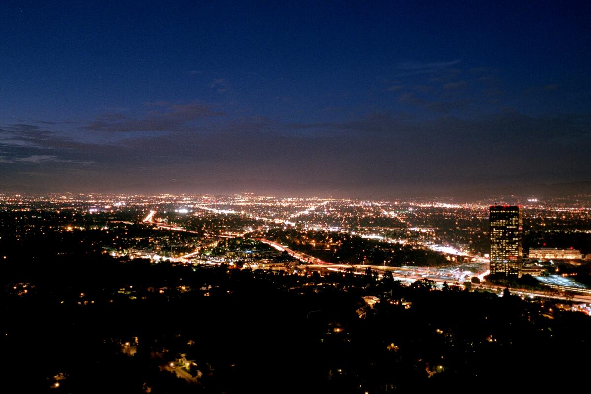 A view over a city illuminated at night. 