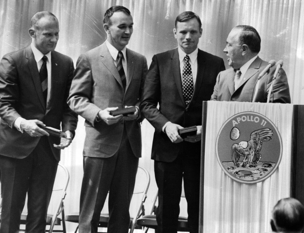 Chicago Mayor Richard J. Daley presents medals to Apollo 11 astronauts Edwin "Buzz" Aldrin, from left, Michael Collins and Neil Armstrong on Aug. 13, 1969, outside the Civic Center. The crowd, estimated at 100,000 people, jammed the Civic Center Plaza to watch the ceremonies honoring the "Moon Men" with medals, making them honorary citizens of Chicago.