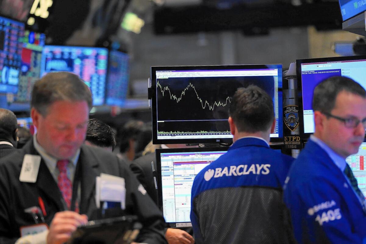 Tuesday's stock losses, the biggest for both major indexes since October, gave back the small gains the indexes had managed to eke out this year. Above, traders work on the floor of the New York Stock Exchange.